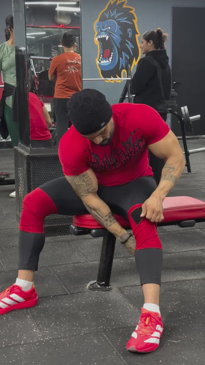 A athlete weraing a powerlifting knee wraps and squating